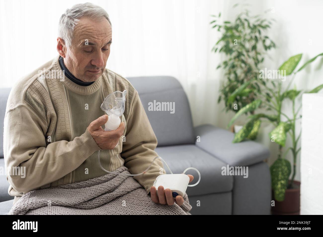 Elderly Senior Man nursing care wear oxygen inhaler device for helping