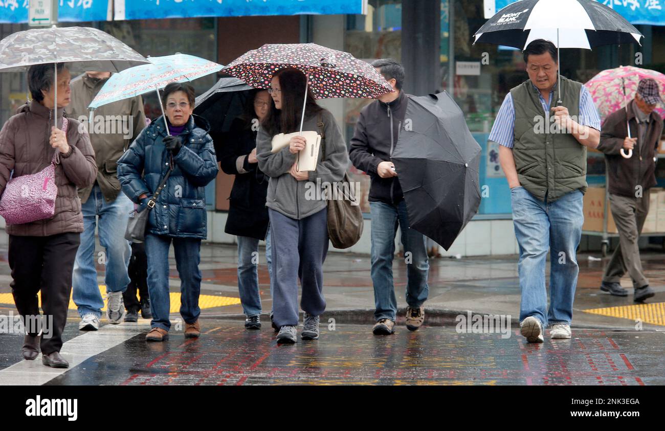 Umbrellas were everywhere as shoppers and pedestrians crossed