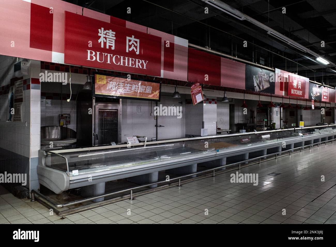 The butchers section has been cleared at a Carrefour store in Wuhan. Carrefour entered the Chinese market in the year 1995 and expanded very quickly, securing a large market share. However earnings began to get smaller as the competition kept on increasing. In the year 2019, the French retailer sold around 80% of its 'loss-making' China business to Jiangsu-based 'Suning' for CNY 4.8 billion which was equal to USD 699 million at the time).This month, reports of shortages at the many local Carrefour store have caught the attention of customers. Several people started complaining that they have b Stock Photo