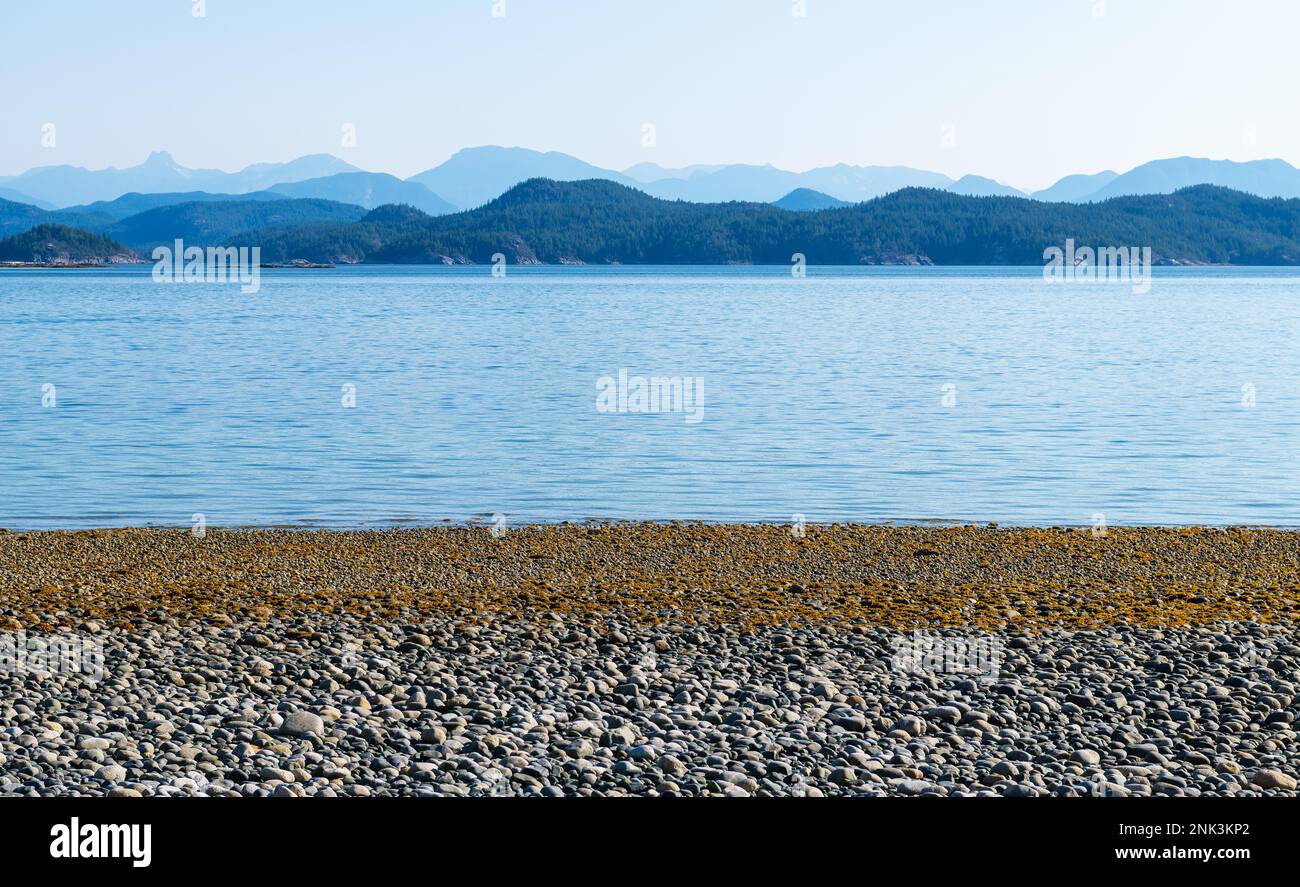 Pebble beach at sunrise, Rebecca Spit Marine Provincial Park, Quadra Island, Vancouver Island, BC, Canada. Stock Photo