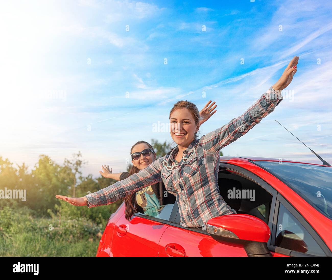 Two young happy girls in a red car Stock Photo - Alamy