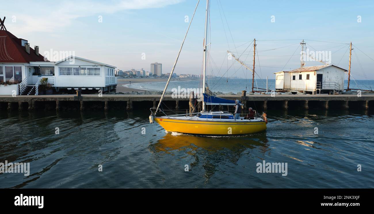 Sometimes in winter when the sea is calm, some boats go out to sea for a short walk   and then return to port, as in this case. Stock Photo