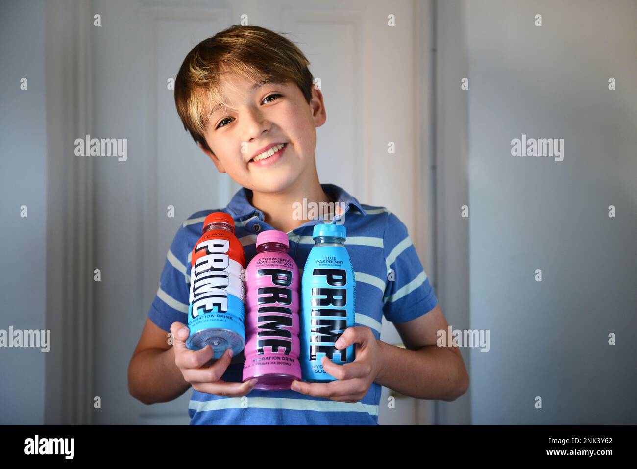 Boy holding prime drinks Stock Photo Alamy