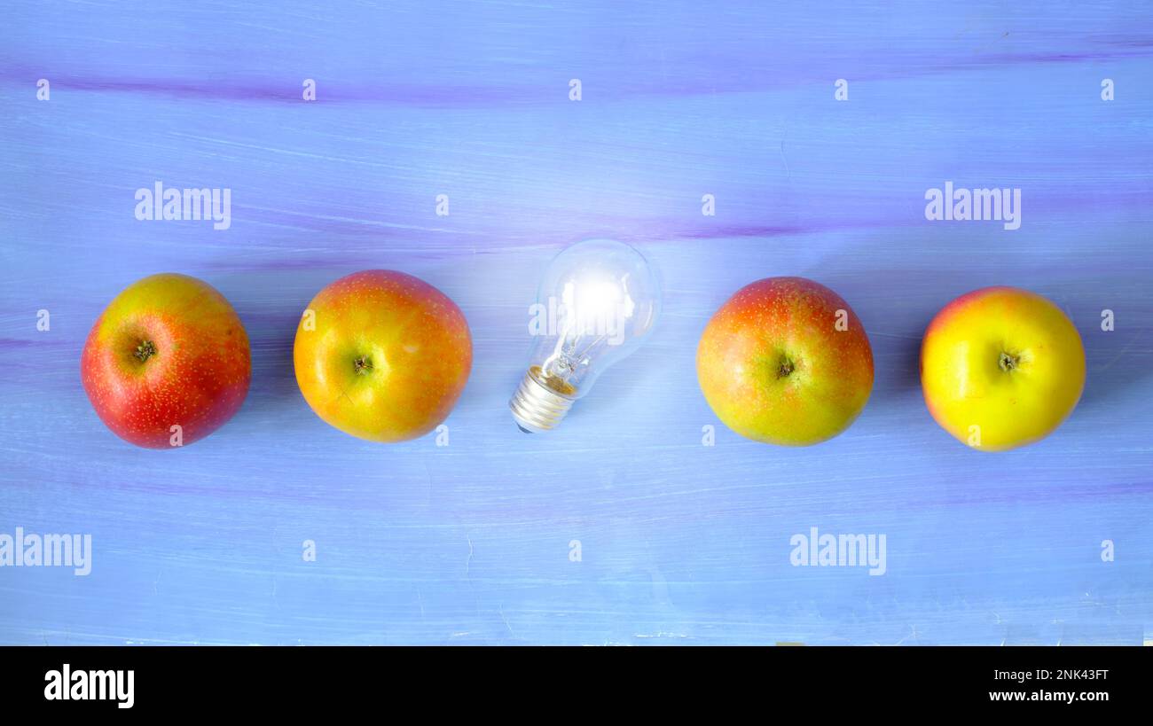 Fresh ideas or business transformation concept with row of apple and light bulb, start up, success, teamwork and creativity business concept Stock Photo