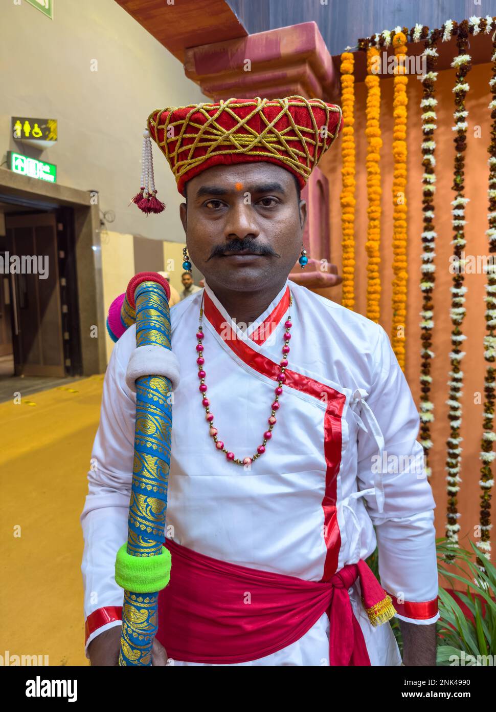 new delhi india november 2022 portrait of an male artist in traditional ethnic dress of maharashtra during the trade fair at delhi 2NK4990