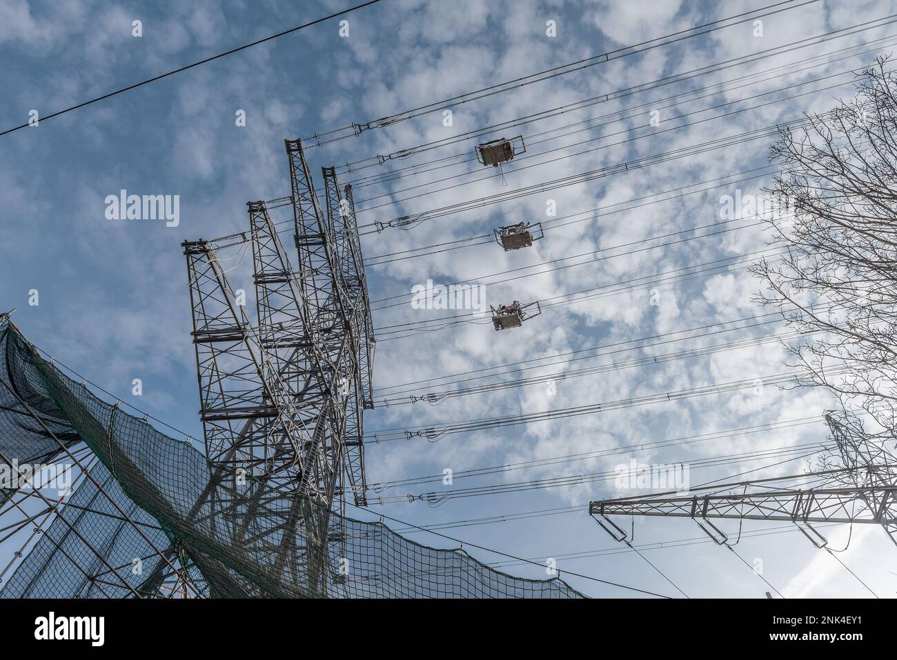 A newly installed high-voltage pylon with some cables connected Stock Photo