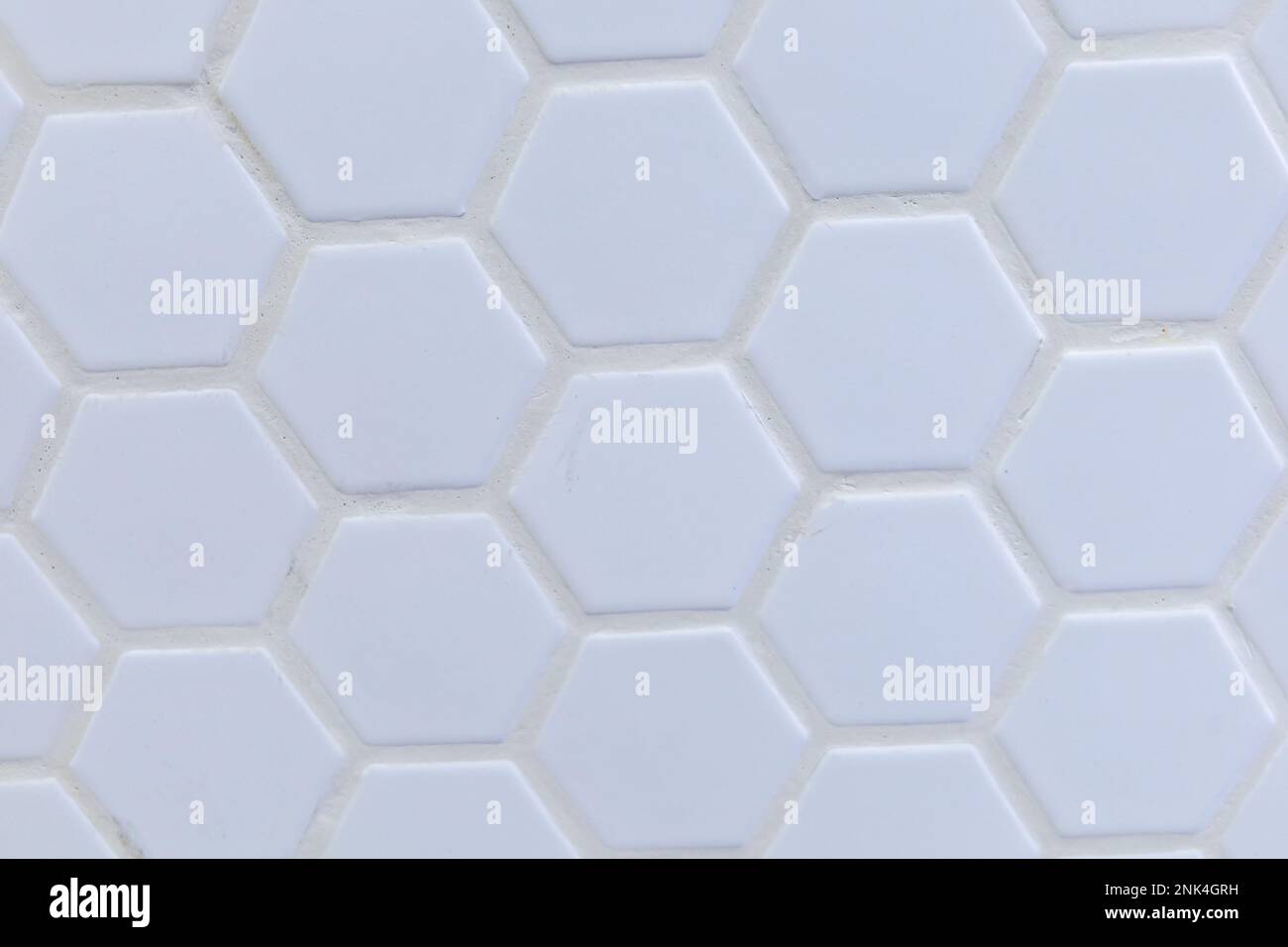 White octagon tile with white grout in a backsplash, shower, bathroom