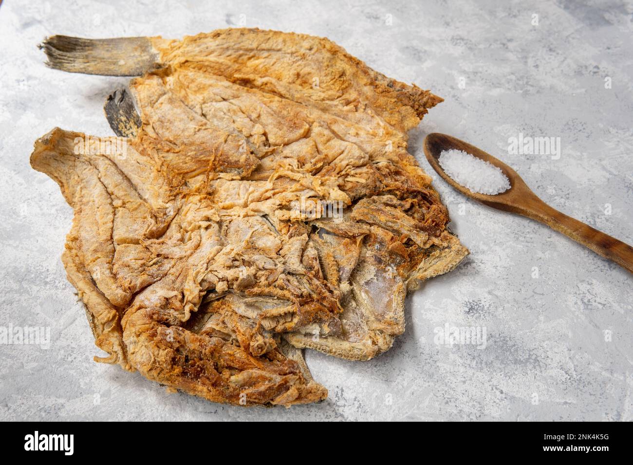 Cod preserved in salting on a light textured surface Stock Photo