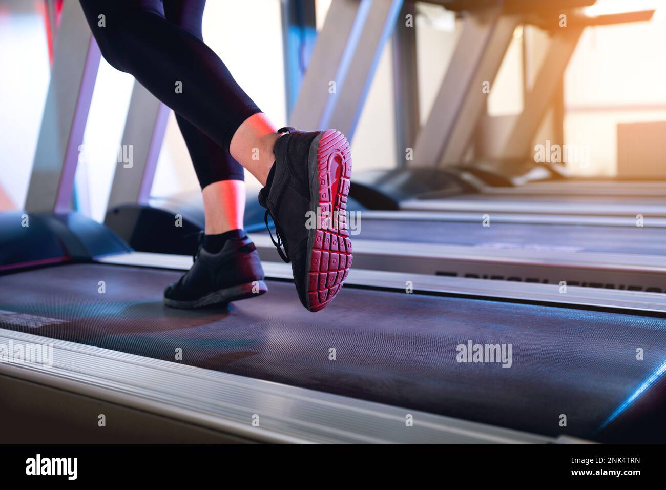 One woman running on a tread mill close up shot to the feet Stock Photo