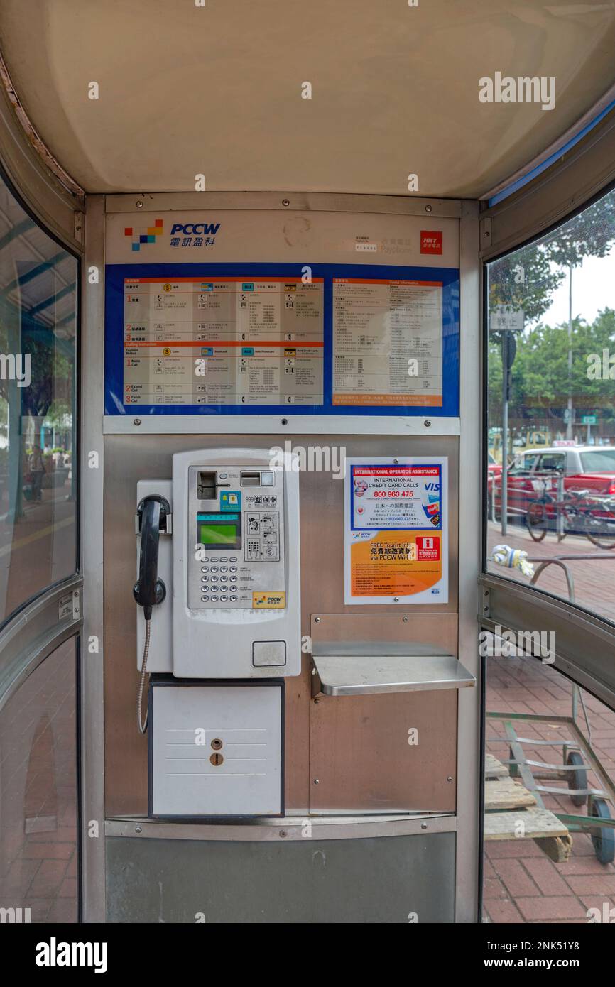 Hong Kong, China - May 1, 2017: Public Telephone Booth Payphone in Working Order by Telecommunication Company Pccw in City. Stock Photo