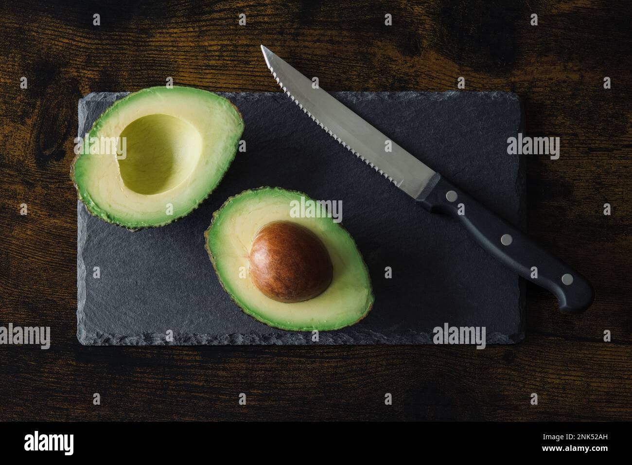 https://c8.alamy.com/comp/2NK52AH/avocado-on-a-black-background-cut-open-high-quality-photo-2NK52AH.jpg