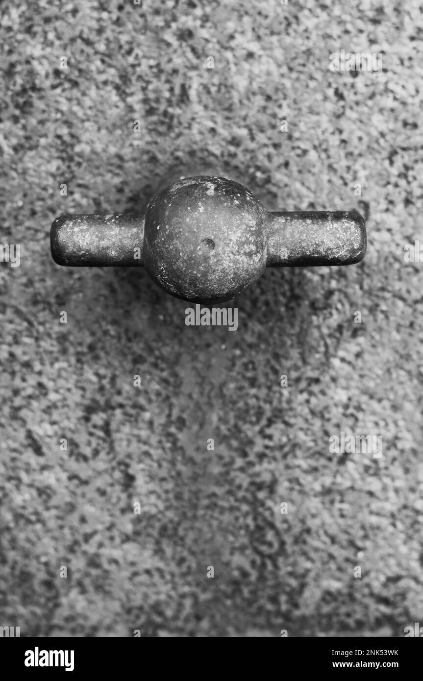 Vintage medieval metal door handle in a black and white monochrome