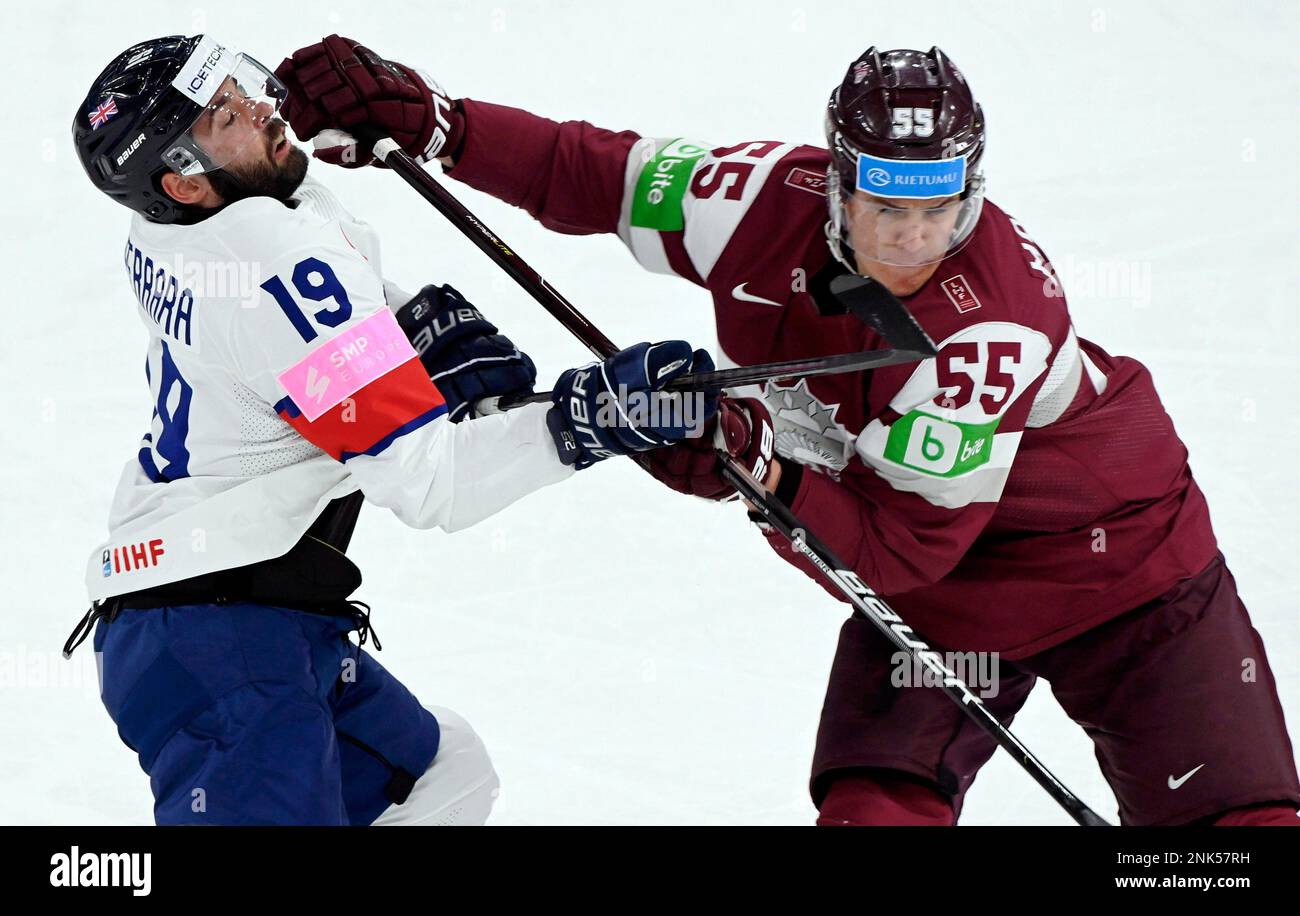 Britains Luke Ferrara, left, vies with Latvias Robert Mamcics during the 2022 IIHF Ice Hockey World Championships preliminary round group B match between Great Britain and Latvia, in Tampere, Finland, Sunday, May