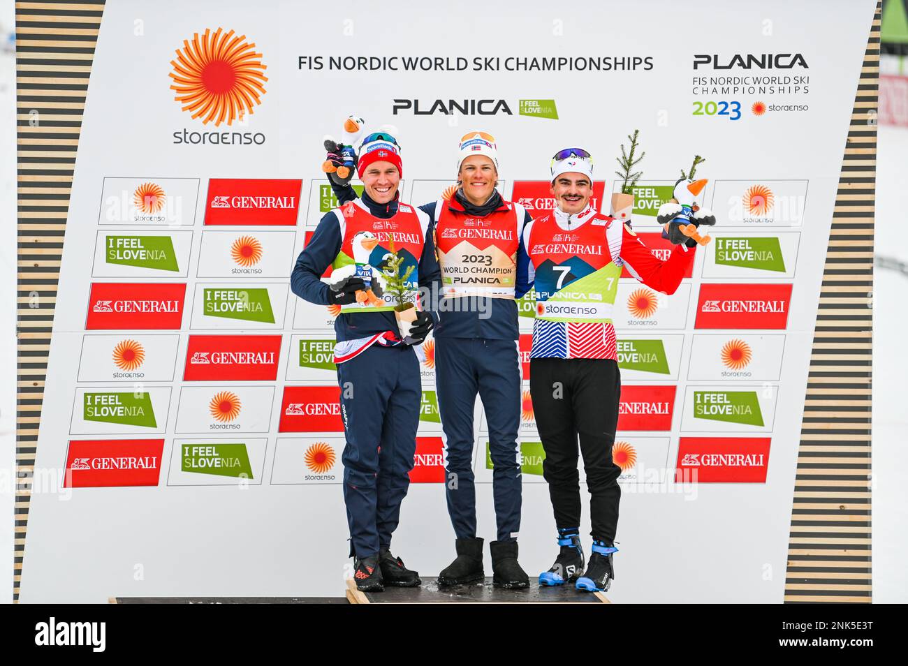 Norway's Johannes Hoesflot Klaebo, center, celebrates after winning the sprint at the 2023 FIS World Nordic Ski Championships in Planica, Slovenia, February 23, 2023. On his right, Paal Golberg (Norway), who finished second, and France's Jules Chappaz, who finished third. Credit: John Candler Lazenby/Alamy Live News Stock Photo