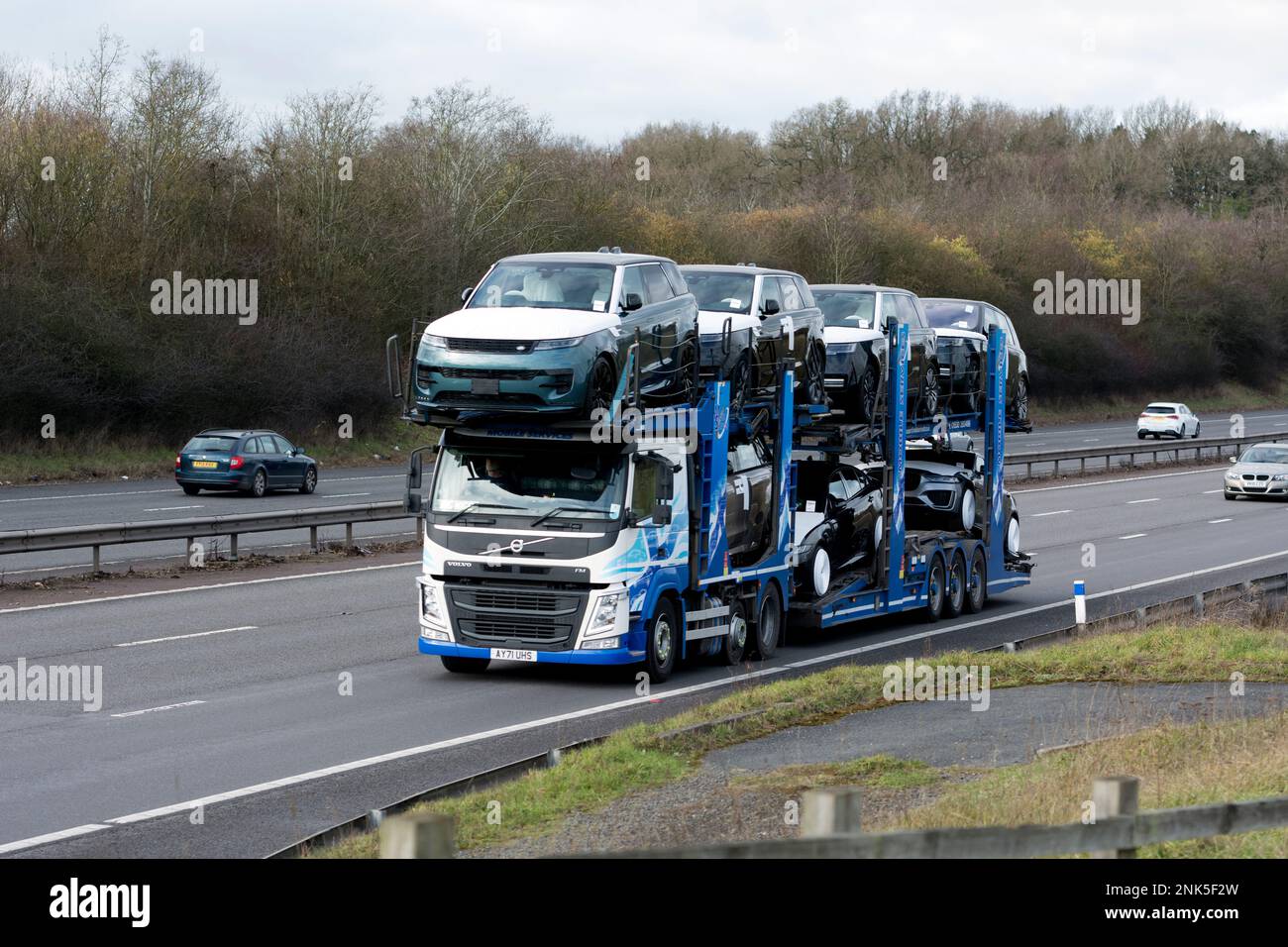 Mobile Services transporter lorry carrying new Land Rover cars, M40 motorway, Warwickshire, UK Stock Photo