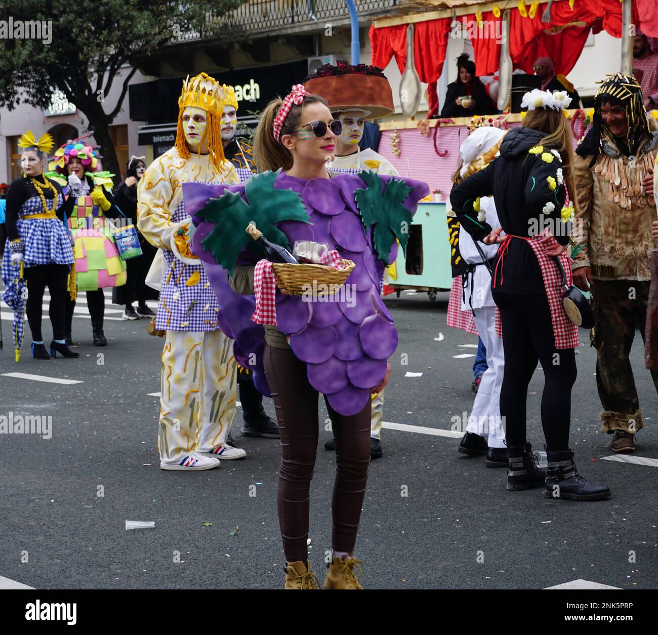 Rijeka, Croatia, 19th February, 2023. Cool girl in a purplish grape costume at the carnival Stock Photo