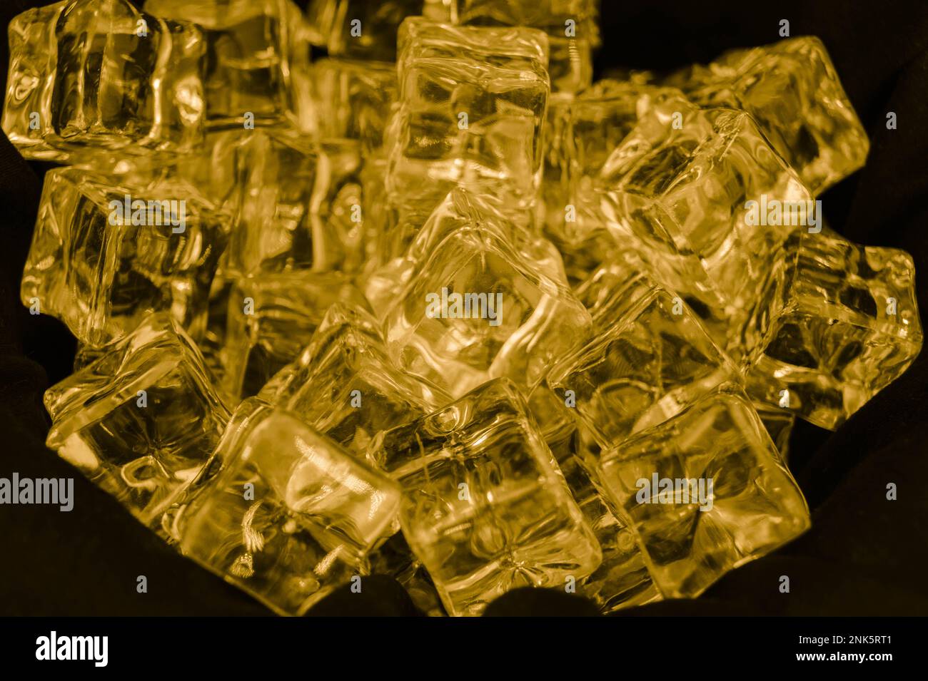 diffuse light shines on a handful of ice cubes Stock Photo - Alamy