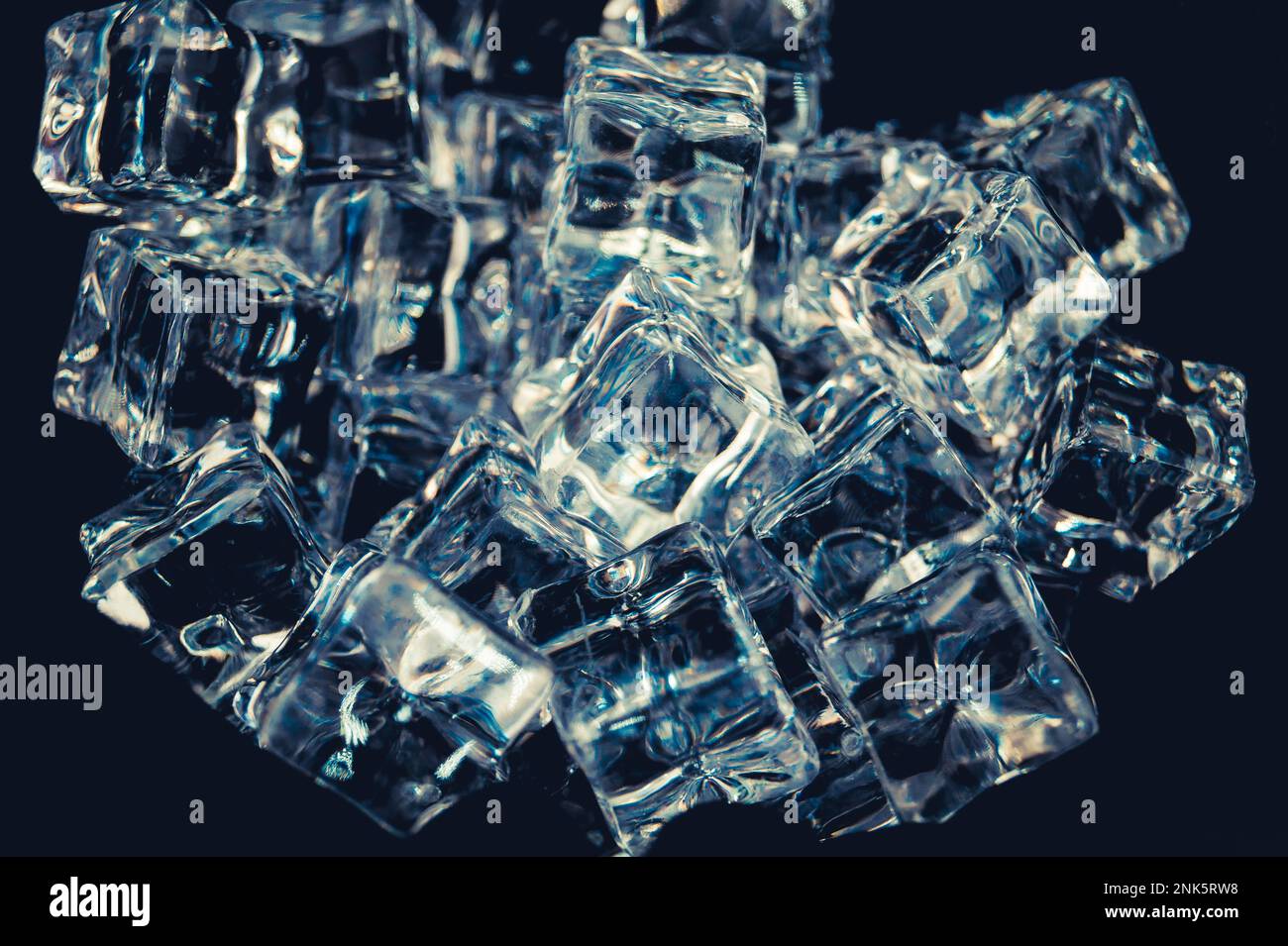 diffuse light shines on a handful of ice cubes Stock Photo - Alamy