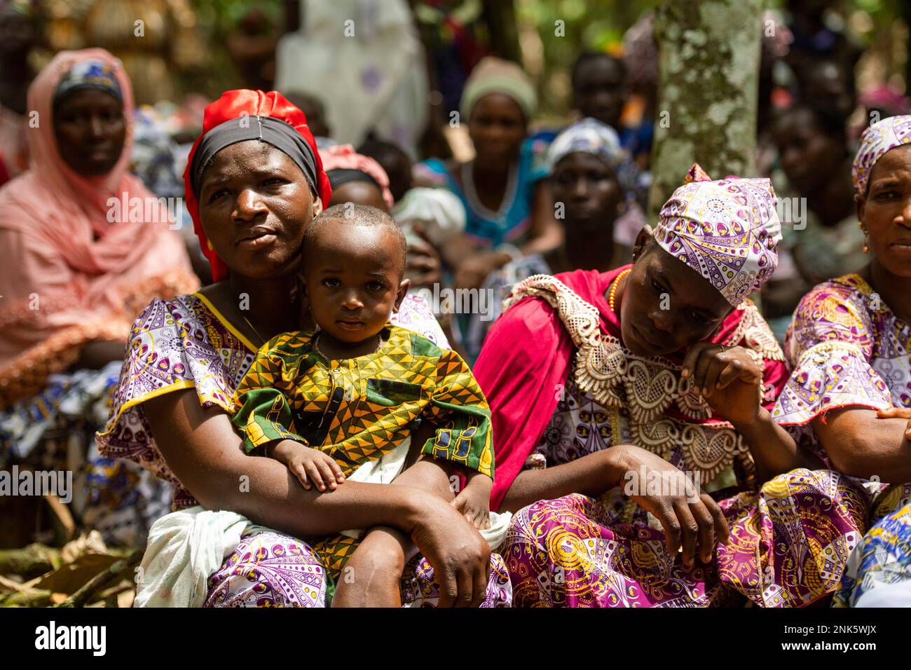 Agboville, Ivory Coast. 23rd Feb, 2023. Harvest workers sit on a cocoa plantation. Federal Minister of Labor Heil and Federal Minister for Economic Cooperation and Development Schulze visit Ghana and Côte d'Ivoire. Credit: Christophe Gateau/dpa/Alamy Live News Stock Photo