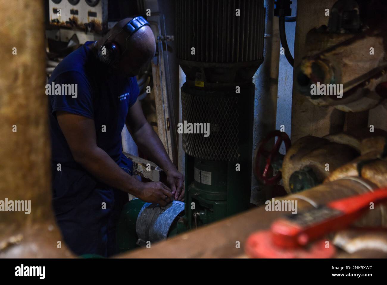 U.S. Coast Guard Petty Officer 1st Class Christopher Wallace, a machinery technician assigned to the USCGC Mohawk (WMEC 913), repairs a pipe fitting in the engine room while underway in the Atlantic Ocean, Aug. 11, 2022. Mohawk is on a scheduled deployment in the U.S. Naval Forces Africa area of operations, employed by U.S. Sixth Fleet to defend U.S., allied, and partner interests. Stock Photo