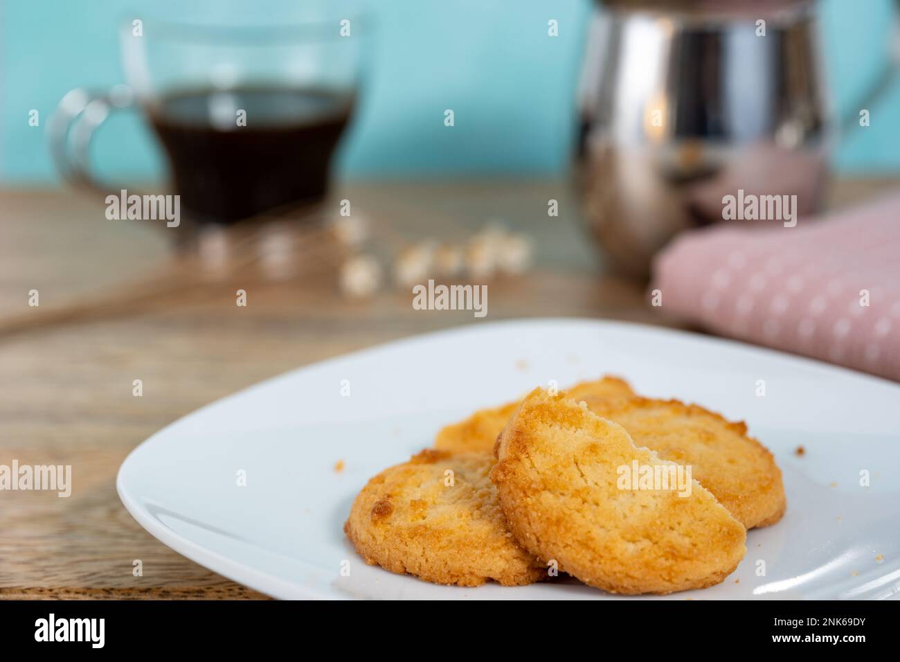 A plate of cookies served alongside a shot of espresso Stock Photo