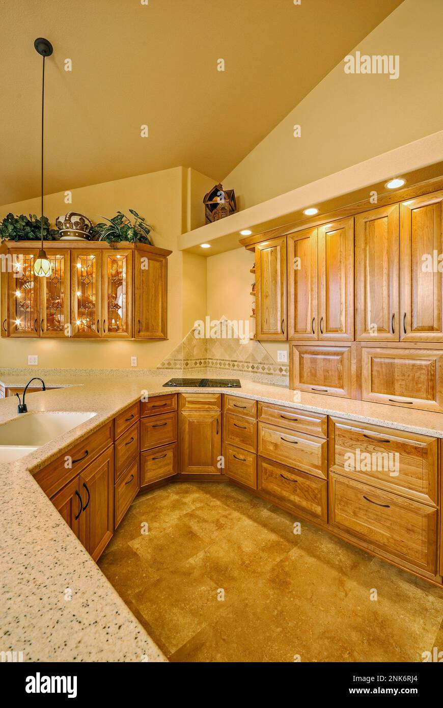 Surrounding wood kitchen drawers, light stone countertops