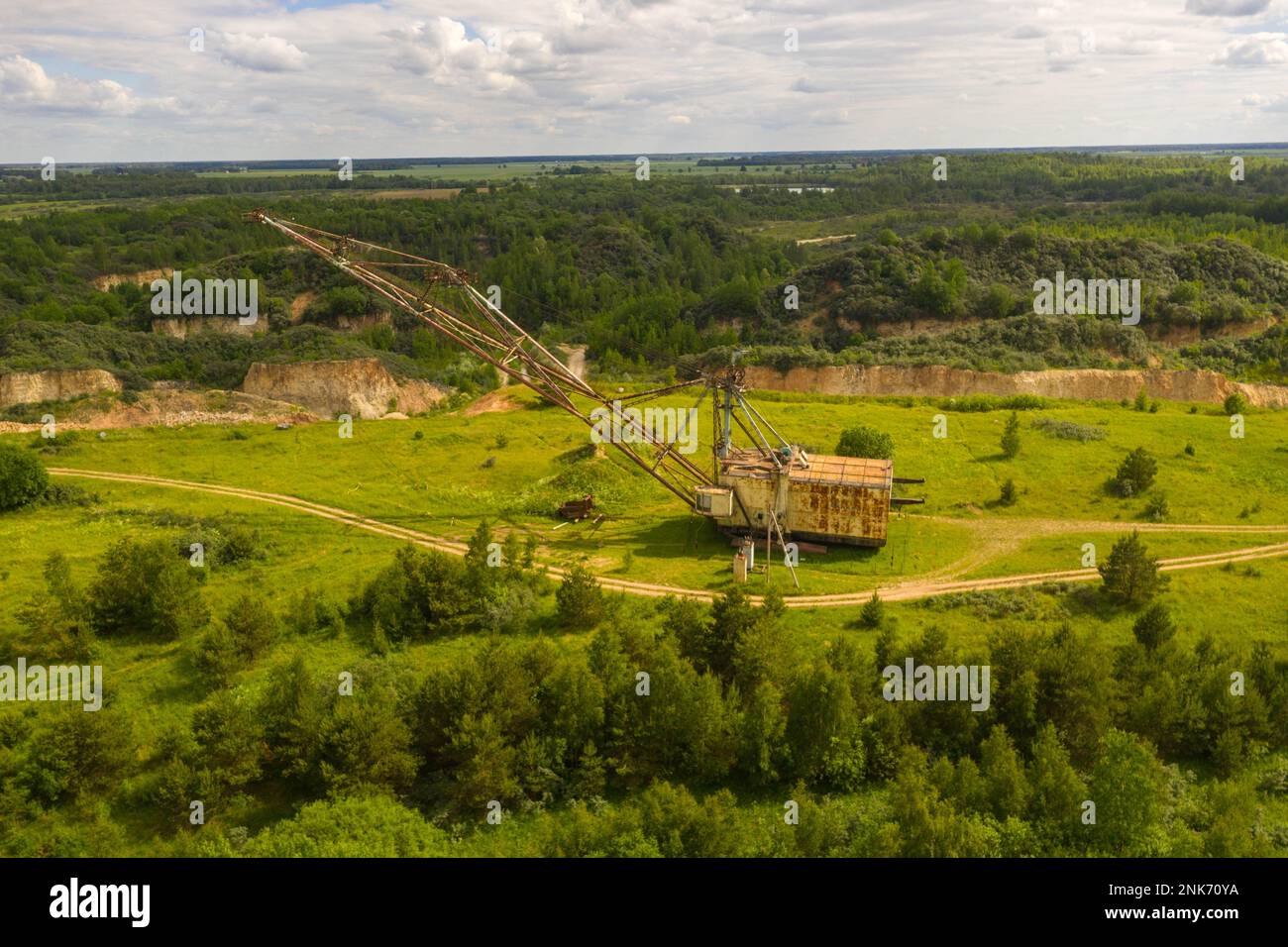 Drone photography of old abandoned excavator in quarry during summer day Stock Photo