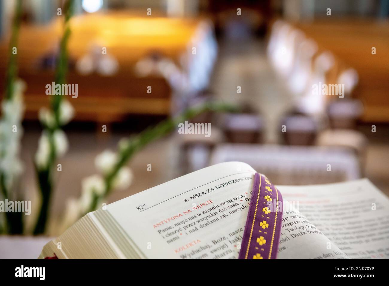 interiors and details in catholic church liturgical book with a church interior blurred in the background Stock Photo