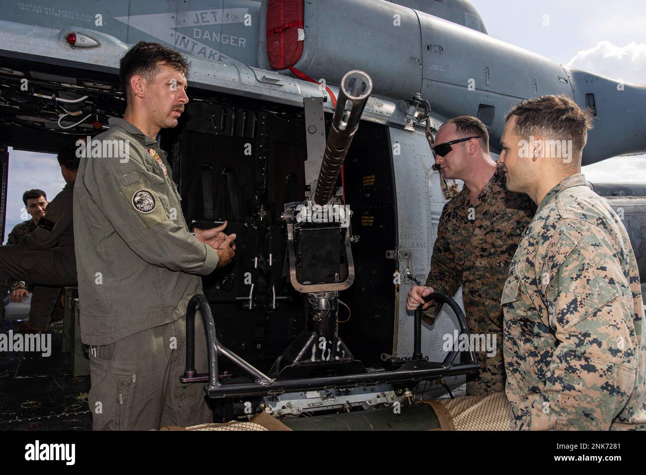 U.S. Marine Corps Sgt. Krecklow, a UH-1Y Huey crew chief with Marine Medium Tiltrotor Squadron 262 (Rein.), 31st Marine Expeditionary Unit, talks about weapon systems during an equipment demonstration aboard USS New Orleans (LPD 18) in the Philippine Sea, Aug. 11, 2022. Apache Company and VMM-262 shared their equipment's capabilties to further improve unit cohesion. The 31st MEU is operating aboard ships of the Tripoli Amphibious Ready Group in the 7th fleet area of operations to enhance interoperability with allies and partners and serve as a ready response force to defend peace and stability Stock Photo