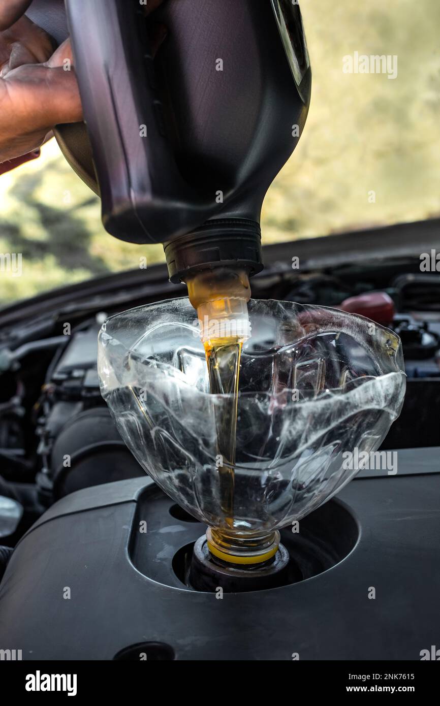 Changing the engine oil in the car engine with your own hands. A man