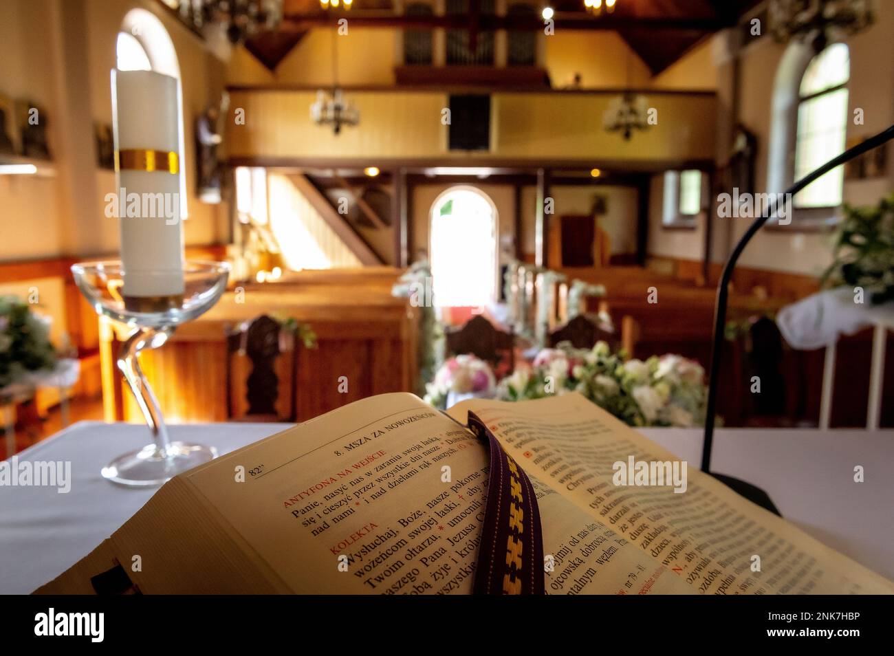 interiors and details in catholic church liturgical book with a church interior blurred in the background Stock Photo