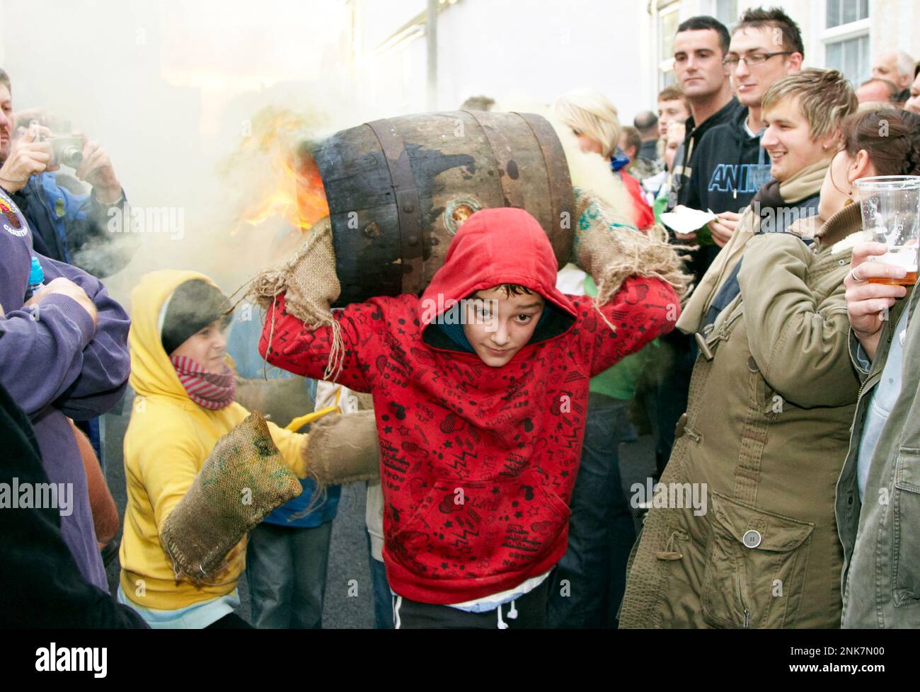 Young Boy Carrying A Burning Tar Barrel Ottery St Mary Devon UK Europe Stock Photo