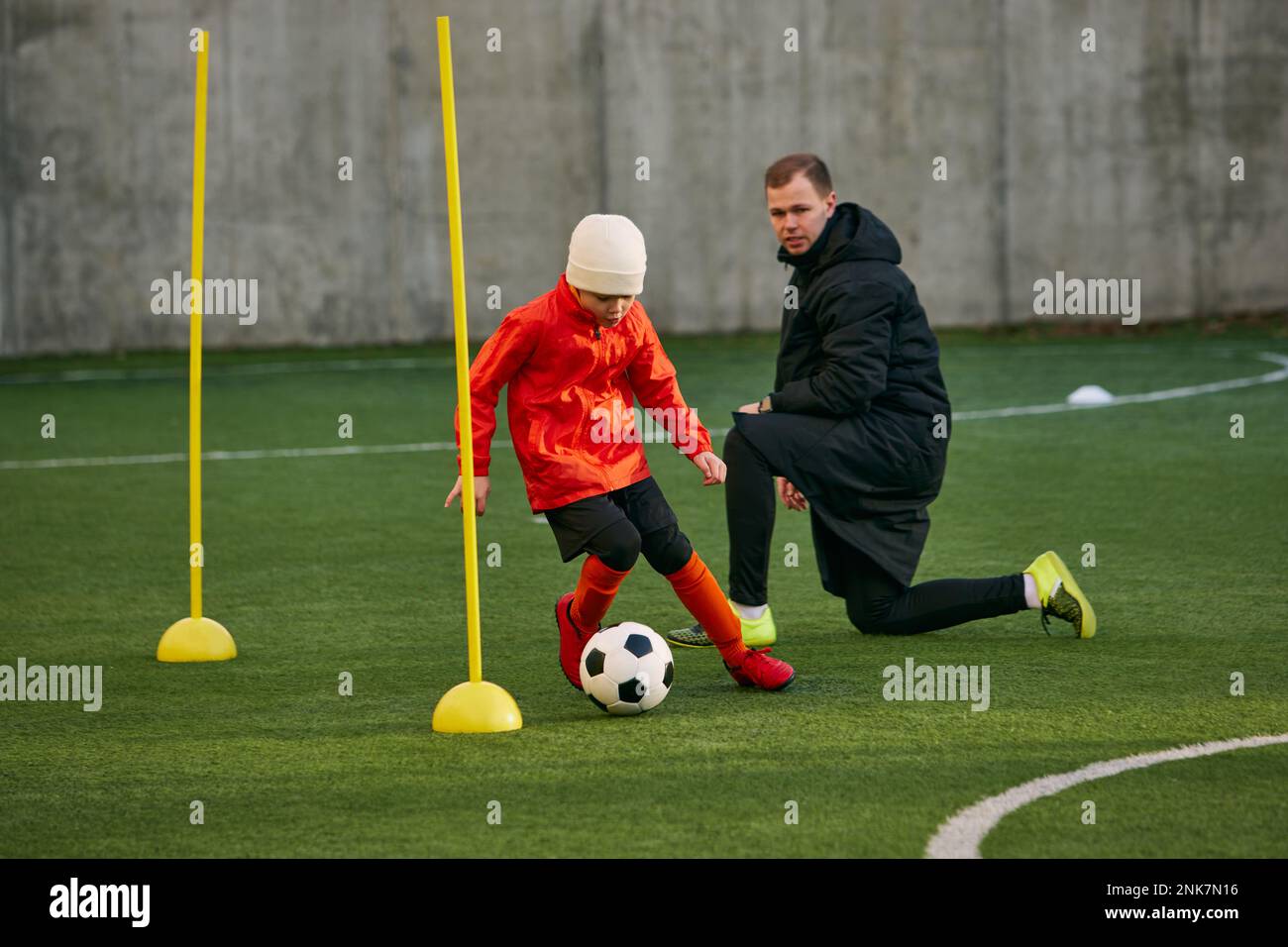 Little boy, child, football player in uniform training with