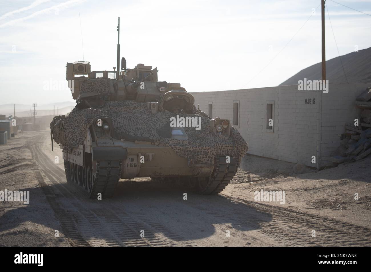 U.S. Soldiers assigned to 1st Battalion, 18th Infantry Regiment, 2nd Armored Brigade Combat Team, 1st Infantry Division maneuver a Bradley Fighting Vehicle through the town of Razish during Decisive Action Rotation 22-09 at the National Training Center, Fort Irwin, Calif., Aug 11th, 2022. Stock Photo