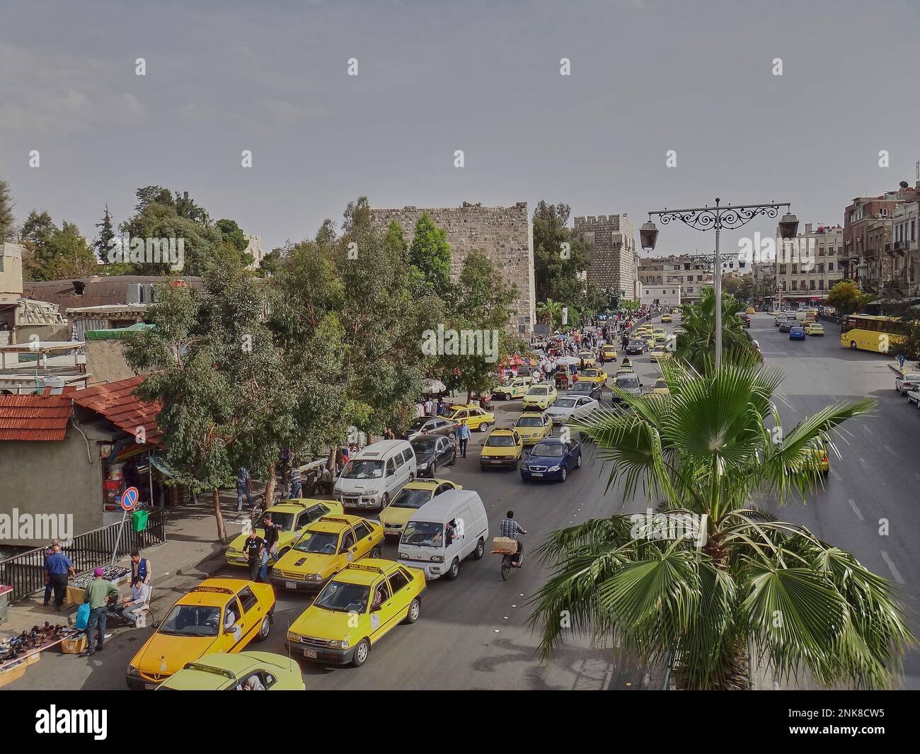 Damascus, Syria - 04 16 2011: yellow taxis and traffic in the city center of Damascus the capital of Syria. Stock Photo