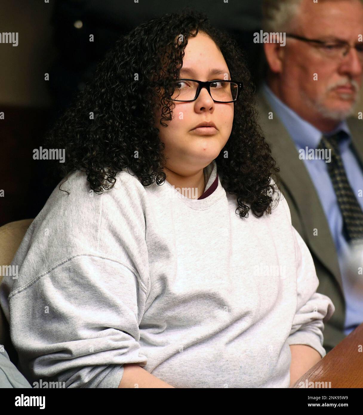 Ruth Correa listens as Eric Lindquist son of Kenneth and Janet