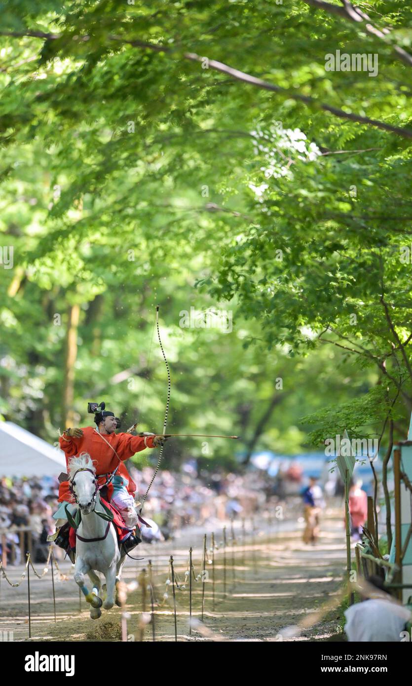 Yabusame Ritual An archer wearing the costumes of court noble on a running horse shoots ...
