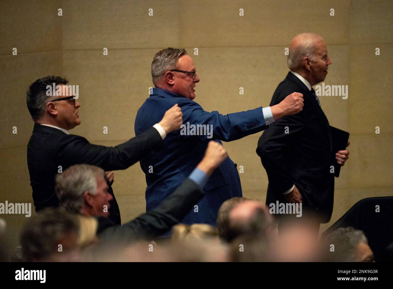 The Mondale sons, William, left, and Ted, stand with President Joe Biden and sing the Minnesota