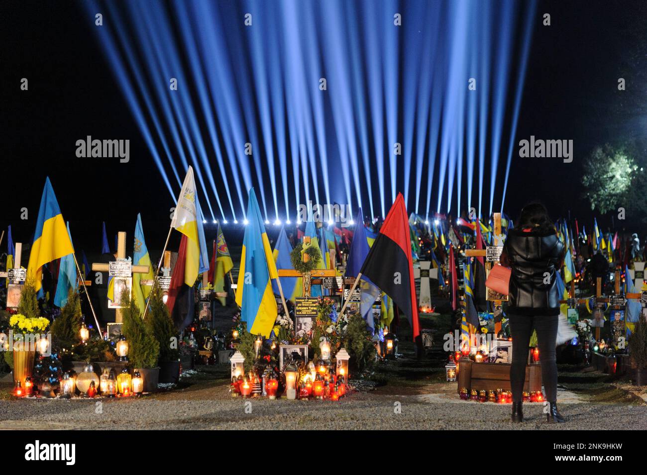 Lviv, Ukraine 23 february 2023. Family members visit the graves of fallen soldiers in the Field of Lychakiv cemetery where hundreds of Ukrainian soldiers who have died over the last year are buried during a commemoration event as symbolic 'Rays of memory' were lit at the Lychakiv military cemetery to mark the first anniversary of Russia's war against Ukraine. Russia invaded Ukraine on 24 February 2022, triggering the largest military attack in Europe since World War II. Stock Photo