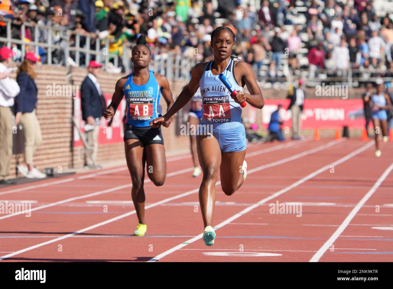 Tia Clayton of Edwin Allen (AA) defeats Oneka Wilson of Hydel (AB) on the  anchor of the Championship of America girls 4 x 100m relay, meet record  43.18 to 43.69, during the