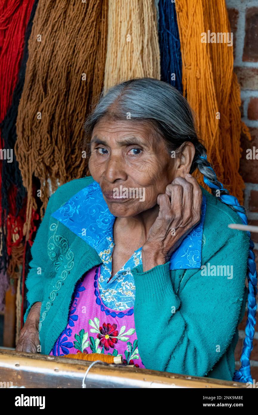 An elderly indigenous Zapotec woman in traditional dress of embroidered