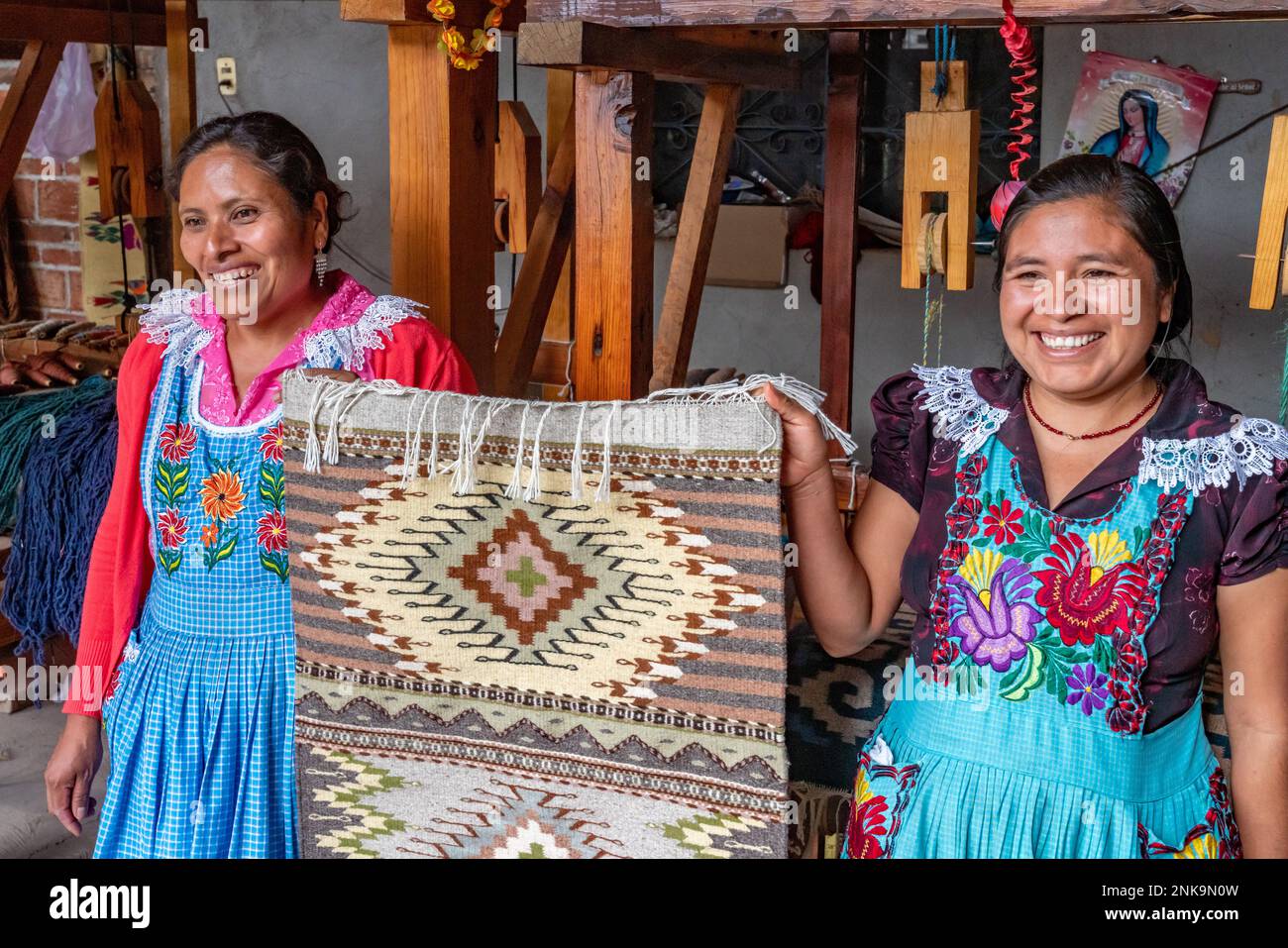 Two indigenous Zapotec women with a rug with Zapotec designs woven on a ...