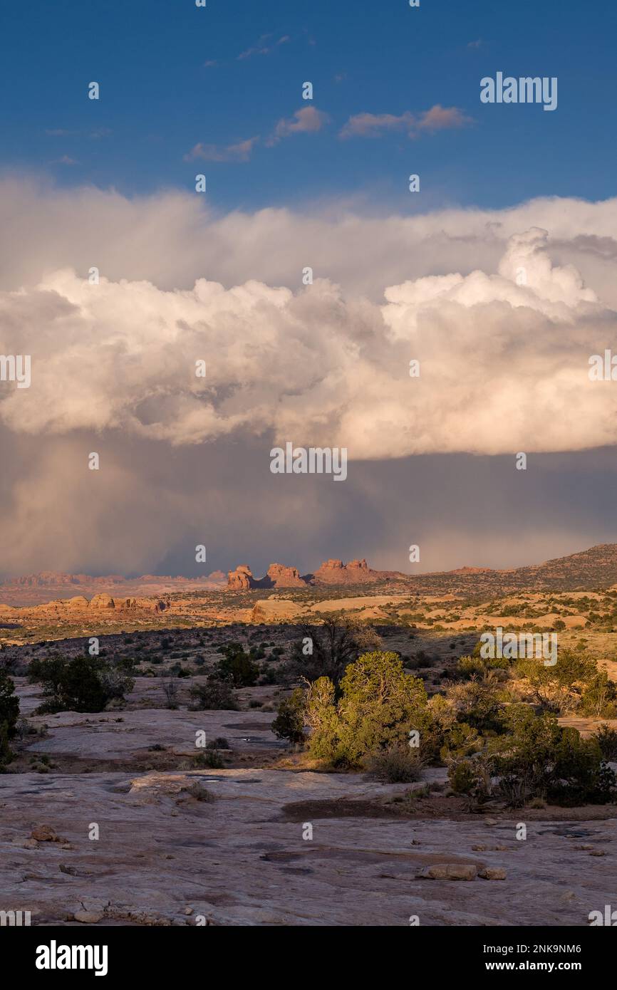 Summer monsoon clouds over Arth's Pasture and Arches National Park, left background, near Moab, Utah, as viewed from the Navajo Rocks area. Stock Photo