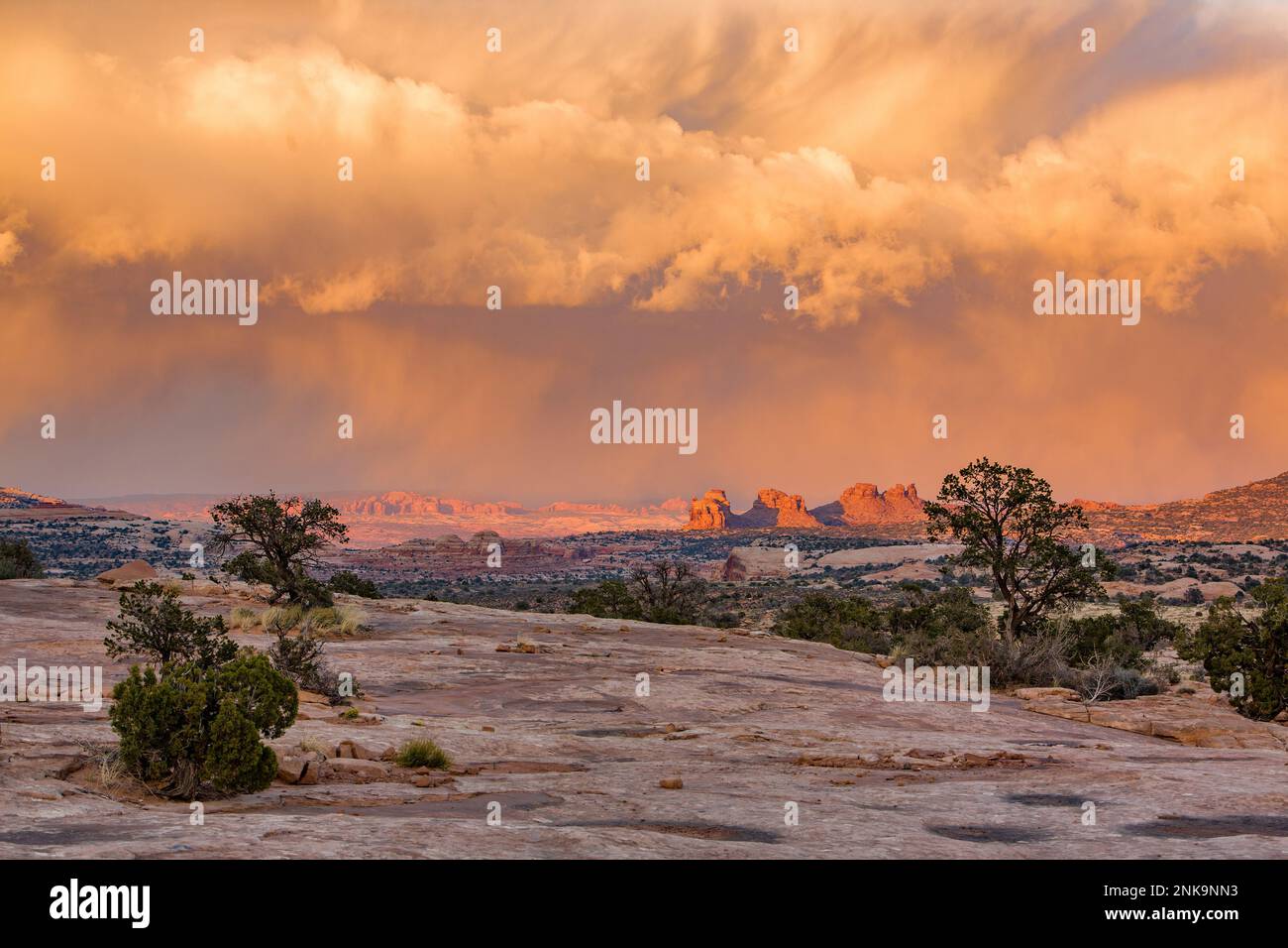 Summer monsoon clouds over Arth's Pasture and Arches National Park, left background, near Moab, Utah, as viewed from the Navajo Rocks area. Stock Photo