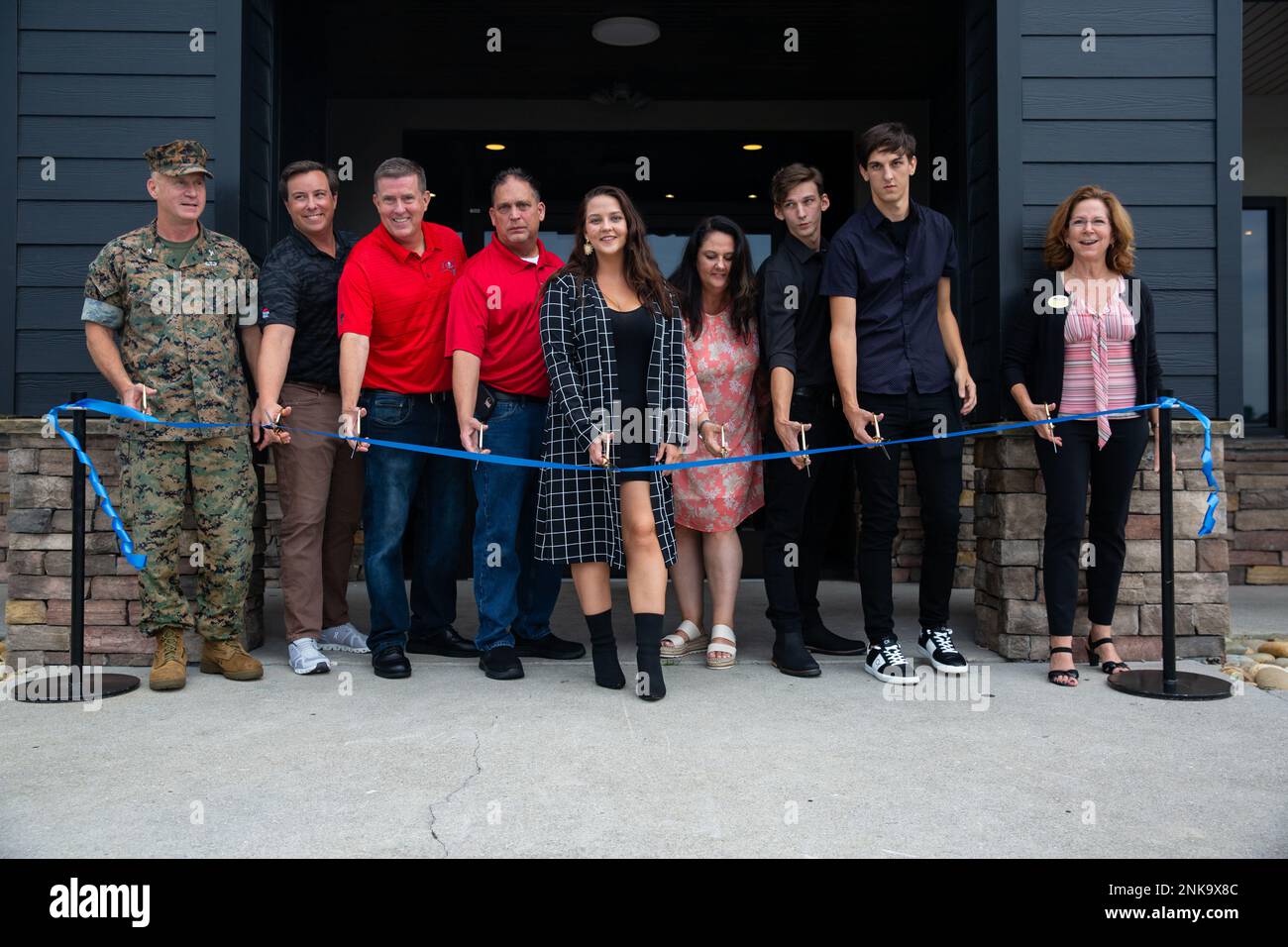 Family members of Gunnery Sgt. Terry Ball and distinguished guests prepare to cut a ribbon during a ceremony in his honor on Marine Corps Base (MCB) Camp Lejeune, North Carolina, Aug. 4, 2022. The former staff noncommissioned officer’s club, dedicated to Ball, was destroyed during Hurricane Florence in 2018 and as a result, Balls memorial was moved to a new location. At a later date, the restaurant and sports bar will be dedicated to Ball for his service to the Marine Corps where he sustained fatal wounds while assigned to India Company, 3rd Battalion, 8th Marine Regiment, 2nd Marine Division, Stock Photo