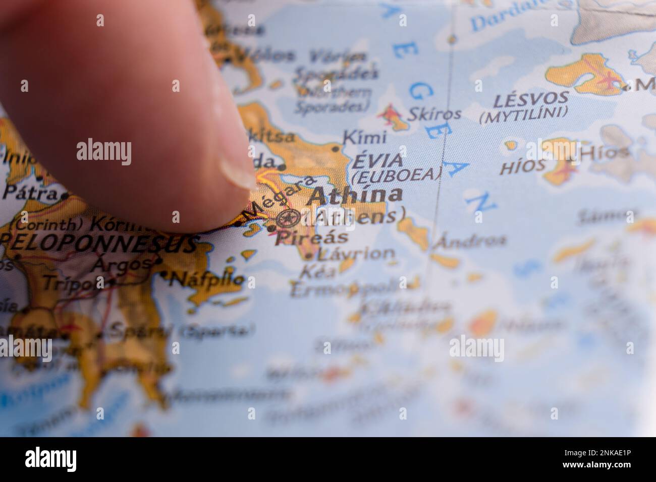 Close up of finger pointing to Athens, Greece on colorful map, background blur Stock Photo