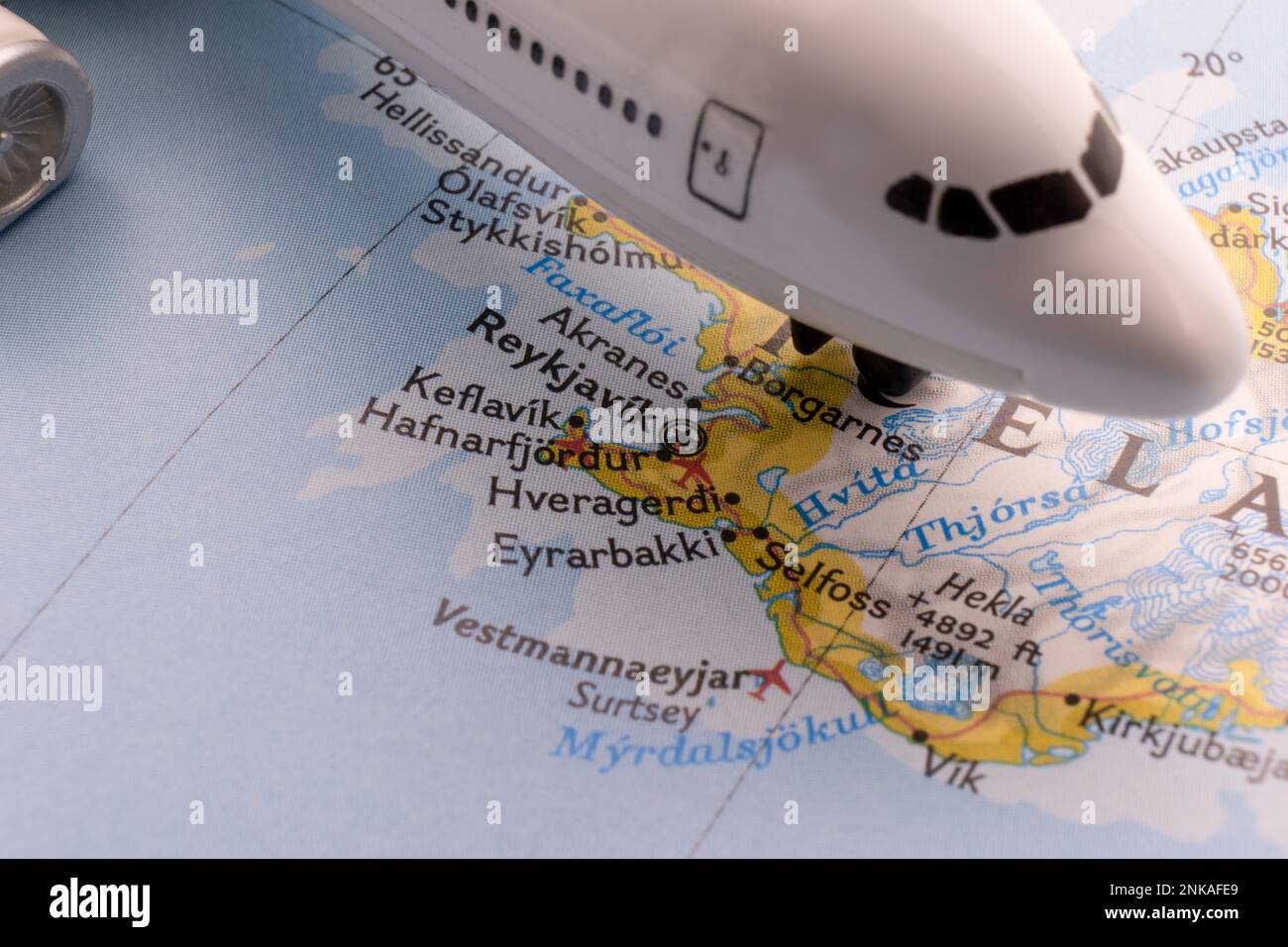 Passenger plane on a map highlighting Reykjavik, Iceland through selective focus, background blur Stock Photo