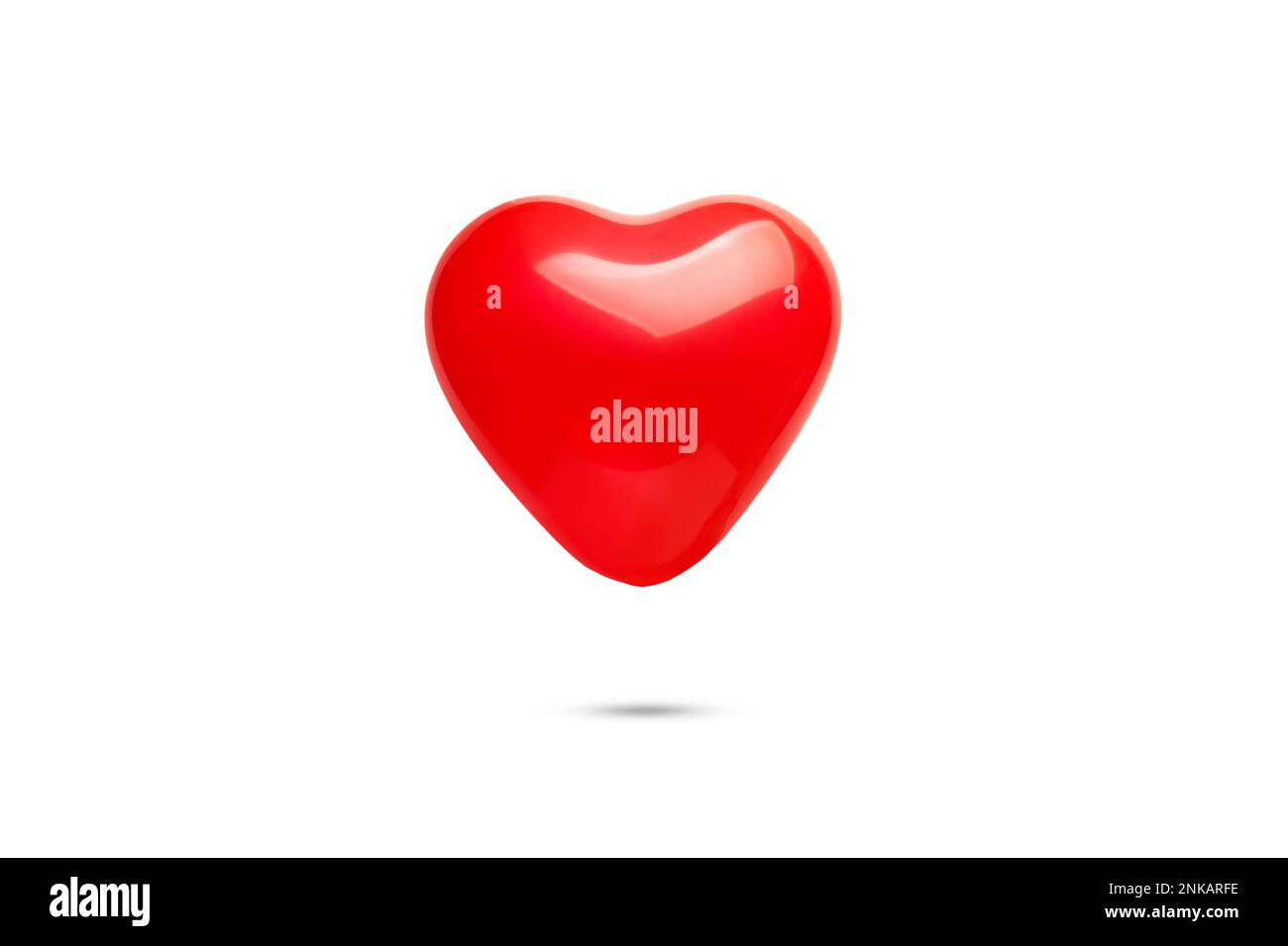 A heart shape red balloon floating on a white background with copy space Stock Photo