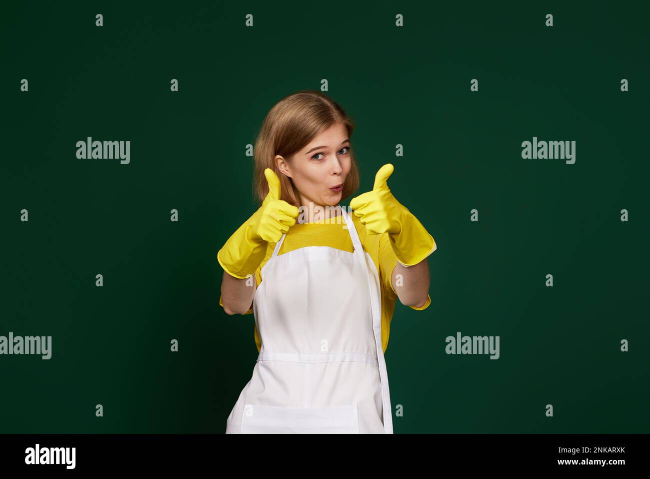woman in rubber gloves and cleaner apron showing ok sign Stock Photo ...