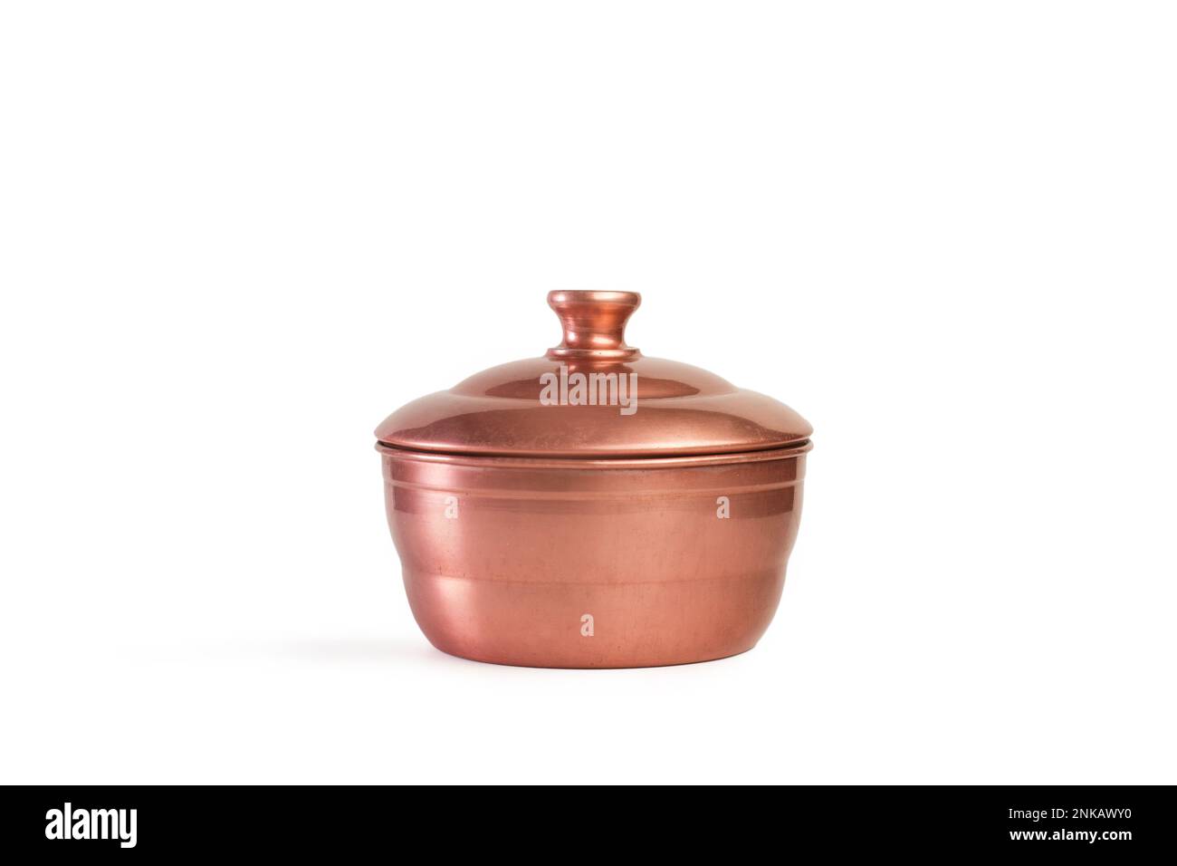 A copper pot with lid on a white background with copy space Stock Photo